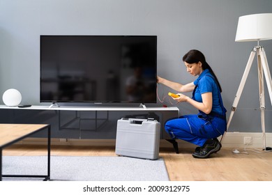 Electrician Repairing Television Or TV Appliance. Fixing Screen