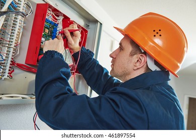 Electrician With Screwdriver Repair Switching Electric Actuator In Fuse Box