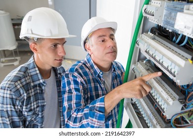 Electrician Showing The Inside Of Electrical Panel Board