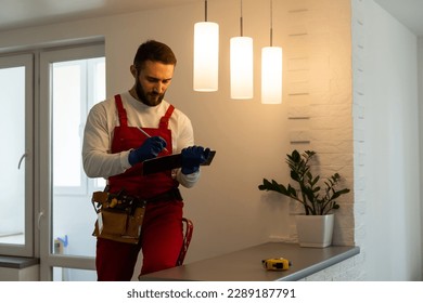 Electrician with tablet indoors, lamp - Shutterstock ID 2289187791