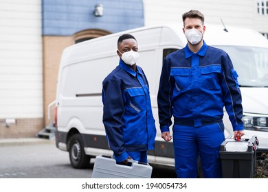 Electrician Technician Or Plumber In Workwear And Face Mask Near Van
