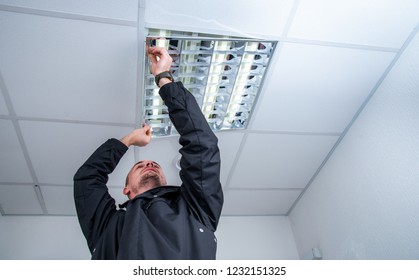 Electrician Technician Repairs Lighting In The Room