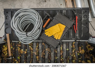 Electrician Tools And Materials On A Pickup Truck Bed Top View. Metal Electric Conduit And Tools Box. Fall Time Construction Theme.