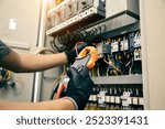 Electrician use electrical measuring tool meter checking circuit breaker power electricity switchboard cabinet for service maintenance and electric cable wiring check for safety concepts.