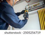 An electrician is wiring the house Electrician Working on Electrical Wiring in a New Construction