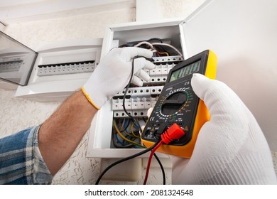 Electrician At Work On An Electrical Panel Protected In Safety Goggles And Gloves; Coronavirus. Construction Industry. Covid 19 Prevention.