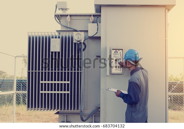 electrician working on checking status\
step up transformer high voltage on transformer yard and solution\
problem to operate at green energy solar power\
plant