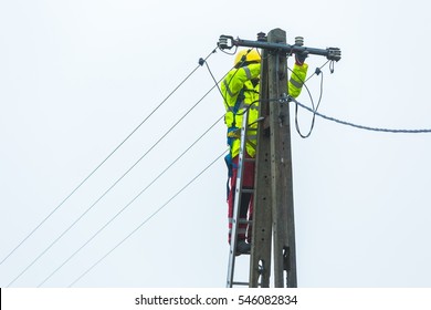 Electrician Working On Power Lines. Failure Of Power Lines On Power Pole.