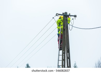 Electrician Working On Power Lines. Failure Of Power Lines On Power Pole.