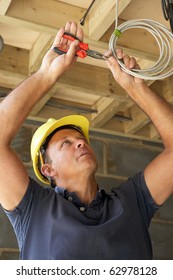 Electrician Working On Wiring In New Home