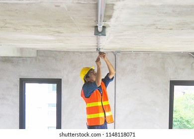 Electrician Working In The Room Maintenance Technicians Install Wiring In The Home.