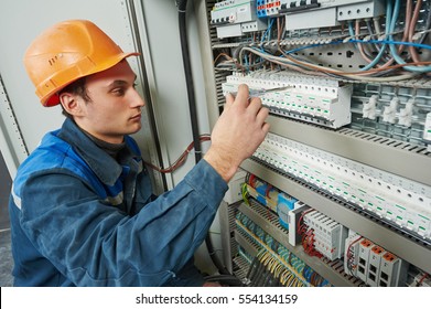 Electrician Works With Electric Meter Tester In Fuse Box