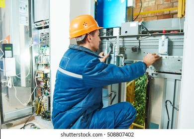 Electrician works with elevator lift equipment