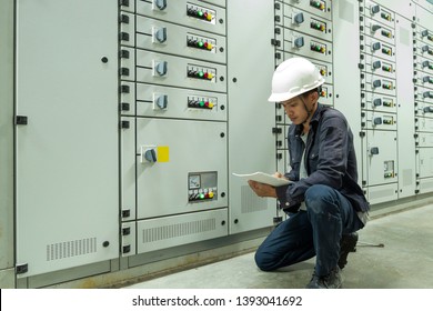 Electricians are checking electrical control panels in industrial plants in Asia. - Shutterstock ID 1393041692