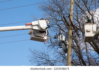 electricians are climbing on electric poles to install and repair power lines wire work man tower - Shutterstock ID 2255928673
