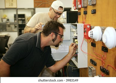 Electricians Learning How To Wire Fire Alarm Systems In A Vocational Training Class.