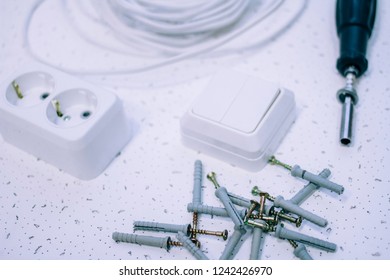 Electrician's set dowel nail, socket, switch, screwdriver - Shutterstock ID 1242426970