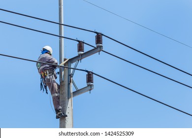 Electricians Wiring Cable Repair Services,worker In Crane Truck Bucket Fixes High Voltage Power Transmission Line,setting Up The Power Line Wire On Electric Power Pole.