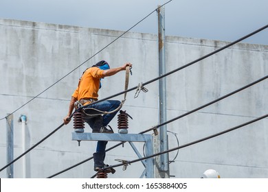 Electricians Wiring Cable Repair Services,worker In Crane Truck Bucket Fixes High Voltage Power Transmission Line,setting Up The Power Line Wire On Electric Power Pole,Soft Focus,selective Focus.