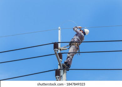 Electricians Wiring Cable Repair Services,worker In Crane Truck Bucket Fixes High Voltage Power Transmission Line,setting Up The Power Line Wire On Electric Power Pole.