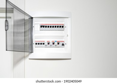 Electricity distribution box in the apartment on a white wall. Fuse box - Shutterstock ID 1902405049