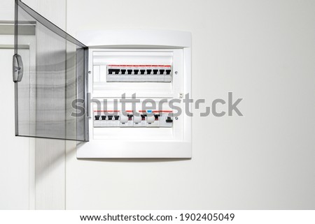Electricity distribution box in the apartment on a white wall. Fuse box