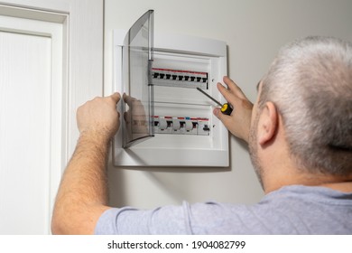 Electricity Distribution Box. Fuse Box. Man Doing Electrical Work