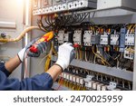 Electricity and electrical maintenance service, Engineer hand holding AC voltmeter checking electric current voltage at circuit breaker terminal and cable .	