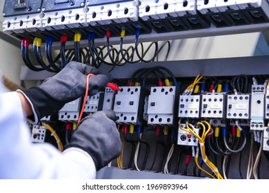 Electricity and electrical maintenance service, Engineer checking electric at circuit breaker and cable wiring system for repairing main power distribution board.