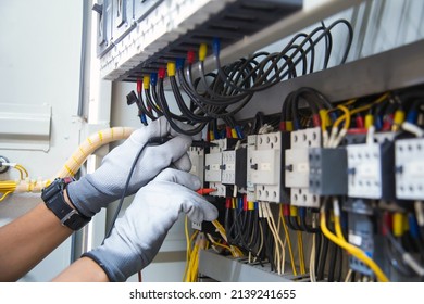 Electricity and electrical maintenance service, Engineer using measuring equipment tool checking electric current voltage at circuit breaker terminal and cable wiring main power distribution board. - Shutterstock ID 2139241655