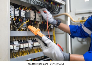 Electricity and electrical maintenance service, Engineer using measuring equipment tool checking electric current voltage at circuit breaker terminal and cable wiring main power distribution board. - Shutterstock ID 2141695951