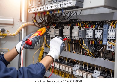 Electricity and electrical maintenance service, Engineer hand holding AC voltmeter checking electric current voltage at circuit breaker terminal and cable .	