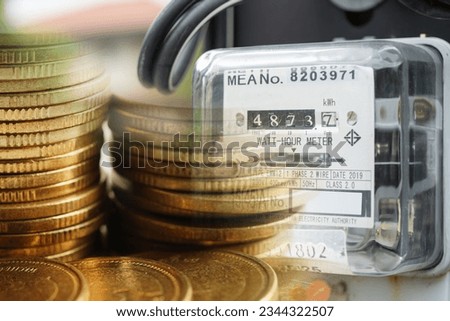 Electricity meter with coins money, Cost expensive fuel energy power bill.
 