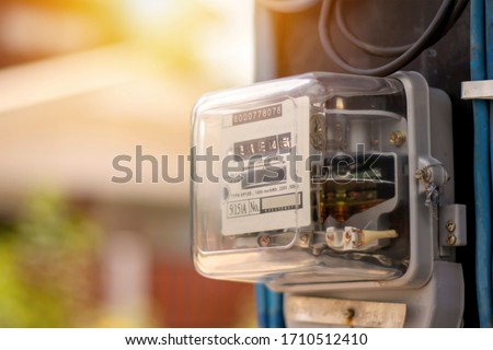 Electricity meters for home electrical appliances, including blurred natural green backgrounds, electric power usage concepts, and electricity usage audits.