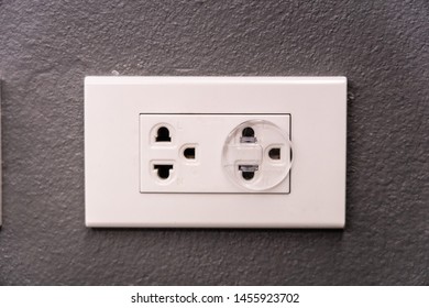 Electricity Outlet On The Wall That's Covered With Safety Plugs. Protection Baby Form Playing With Plug. Safety First Concept. Covering Plug Holes Of The Surge Protector.