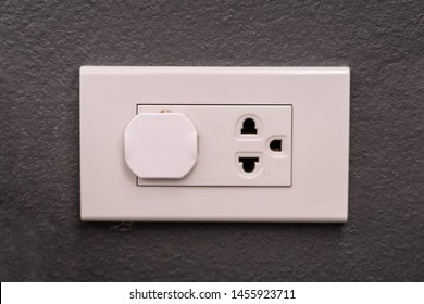 Electricity Outlet On The Wall That's Covered With Safety Plugs. Protection Baby Form Playing With Plug. Safety First Concept. Covering Plug Holes Of The Surge Protector.