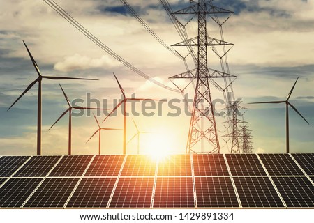 electricity power in nature. clean energy concept. solar panel with turbine and tower hight voltage sunset background
