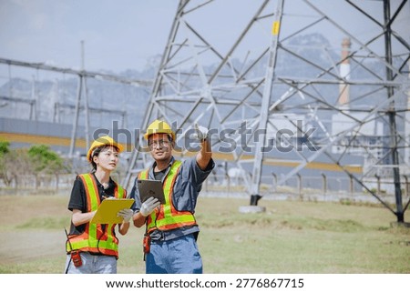 Electricity professional engineer working team against power plant background and power line grid survey inspector