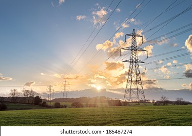 Electricity Pylon - UK standard overhead power line transmission tower at sunset. - Shutterstock ID 185467274