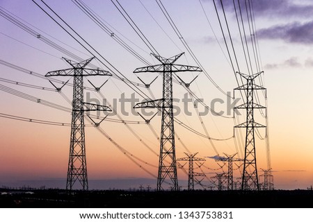 Electricity pylons during dusk evening sky sunset.