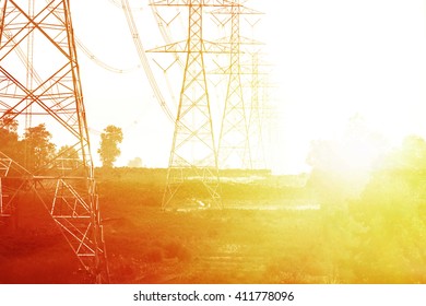 Electricity Pylons And Lines At Sunset