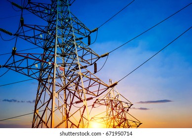 Electricity Pylons At Orange Sunset