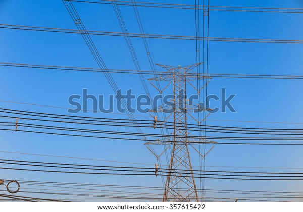 Electricity tower and electric line, power\
line in blue sky\
background