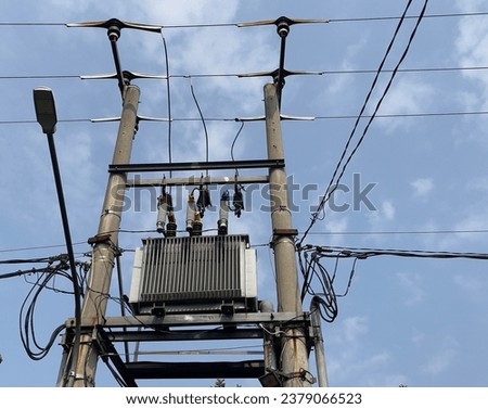 Electricity tower with transformer, it supply electrical to nearby house with blue sky background