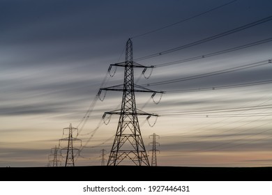 Electricity Towers or Electricity Pylons carrying high voltage electric power across the UK carrying energy from fossil fuel power stations during an energy crisis and gas pricing
