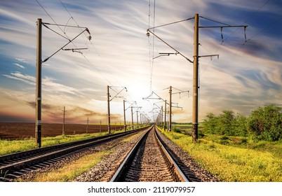 Electrified railway with two tracks on a background of sunset with a beautiful sky