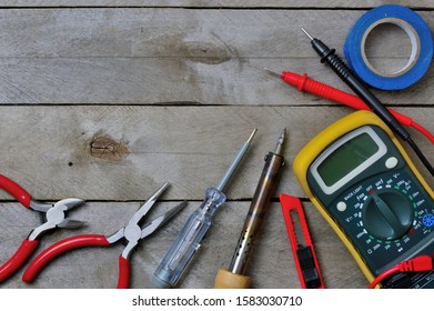 Electro Tool And Tester On A Wooden Background. Copy Space