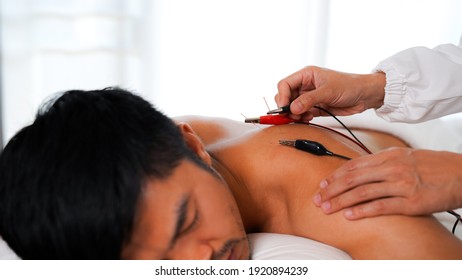 
Electro-Acupuncture. Chinese acupuncture and electric acupuncture on the patient's body to treat pain.