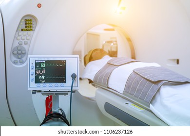 Electrocardiogram In Hospital CT Scan Room. Heart Rate Monitor In Hospital. Process Of CT Scanning Of An Old Patient. Man Receiving A Medical Scan For A Trauma