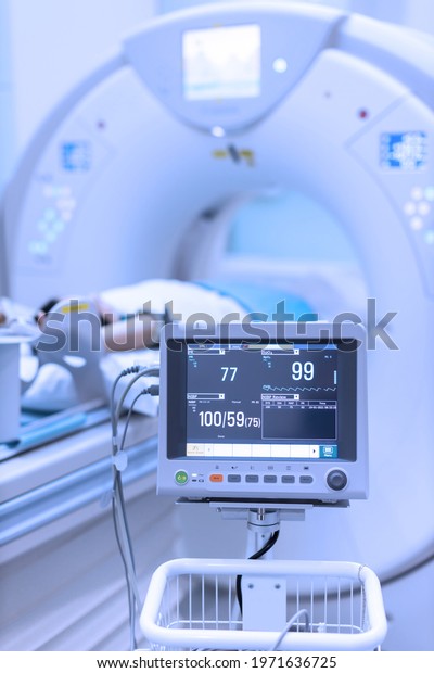Electrocardiogram in hospital CT Scan room.\
heart rate monitor in hospital. Process of CT scanning of an old\
patient. Man Receiving a Medical Scan for a\
Trauma
